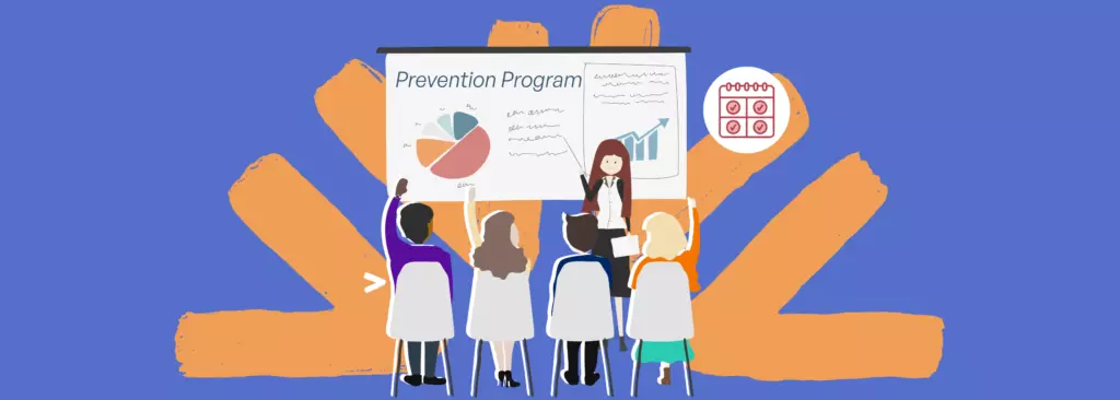 An instructor stands by a board labeled “Prevention Program,” teaching a group of engaged participants in a classroom-style setting; several people raise their hands, illustrating adults building their understanding of childhood sexual violence and how to prevent and respond to it.